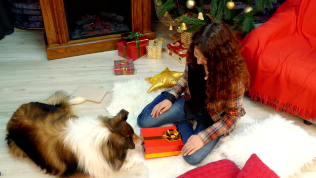 A-girl-gives-a-gift-with-cookies-to-her-dog