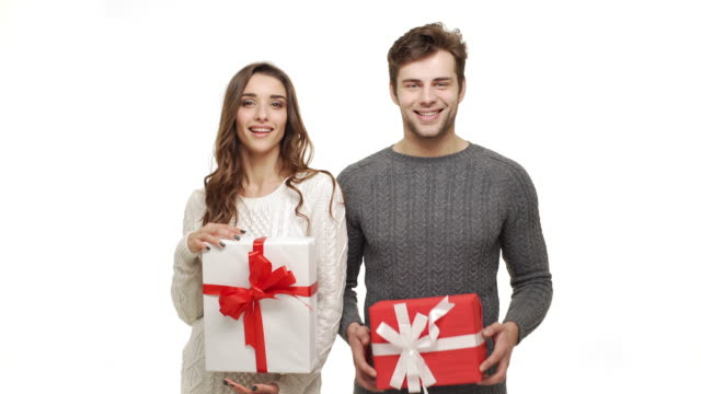 4k-Young-couple-showing-presents-in-Chrismas-day-on-white-background.