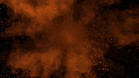 Orange-powder-exploding-on-black-background-in-super-slow-motion