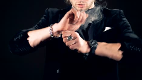 Slow-motion-footage-of-illusionist's-hands-producing-smoke