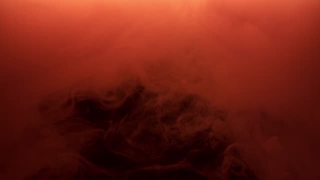 Red-ink-spraying-in-water-on-black-background.