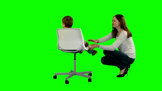 Mother-and-boy-play-game-on-a-Green-Screen