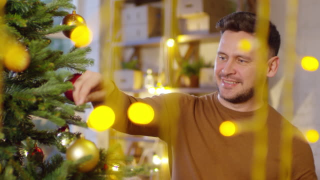 Hombre-caucásico,-sonriendo-y-decoración-árbol-de-Navidad