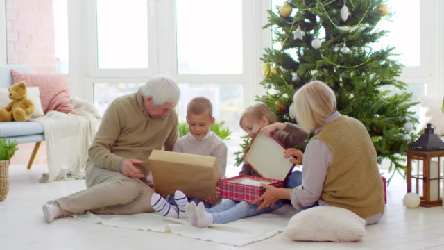 Children-Getting-Christmas-Presents-from-Grandparents
