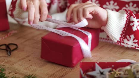 Close-up-of-woman's-hands-wrapping-the-christmas-gifts