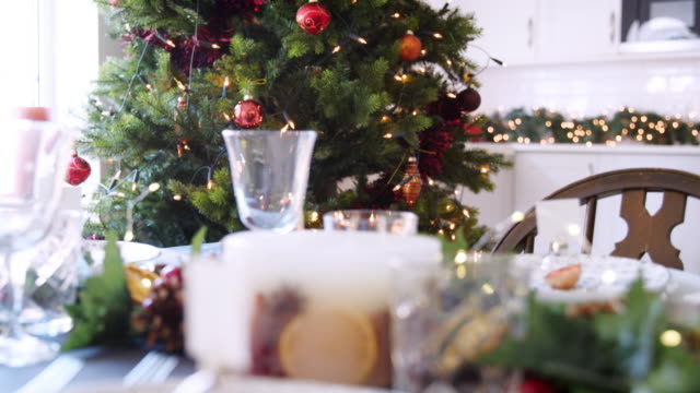 Tilt-shot-of-a-bauble-name-card-holder-arrenged-on-a-Christmas-dinner-table,-close-up