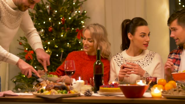 happy-friends-having-home-christmas-dinner-party
