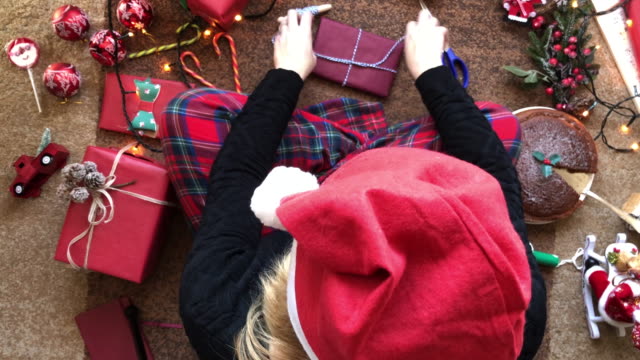 Woman-wrapping-Present-and-Christmas-Flat-Lay