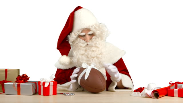 Santa-Claus-ist-binden-Sie-eine-Schleife-auf-einen-Football