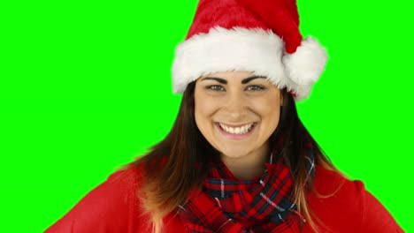 Festive-brunette-in-santa-hat-blowing-over-hands