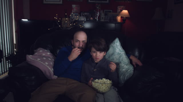 4k-Authentic-Shot-of-a-Child-watching-Football-with-his-Dad