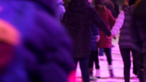 Concept-Winter-Sport.-Crowd-at-Night-City-Skating-Rink.-Falling-Snow.-Zoom-Out