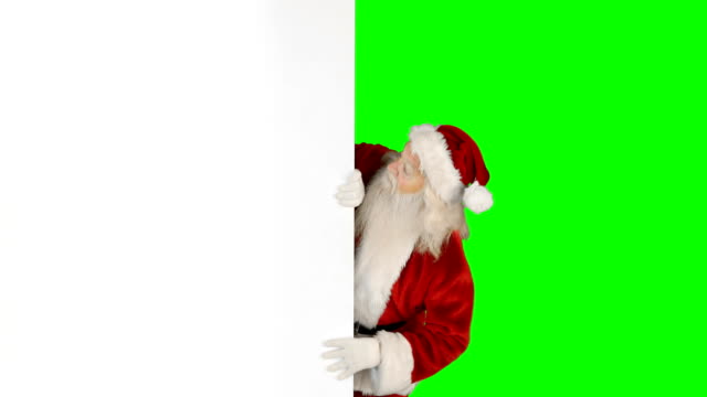 Santa-claus-hiding-behind-green-screen