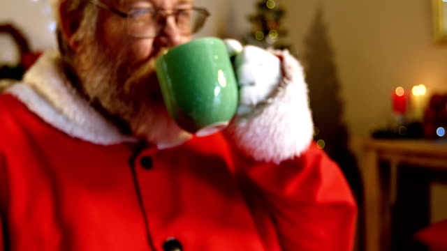 Santa-claus-relaxing-on-chair-and-having-coffee