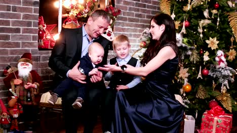 Parents-play-with-children,-happy-family-New-Year's-eve,-portrait-of-a-happy-family,-mother,-father-and-sons-celebrating-Christmas-Eve