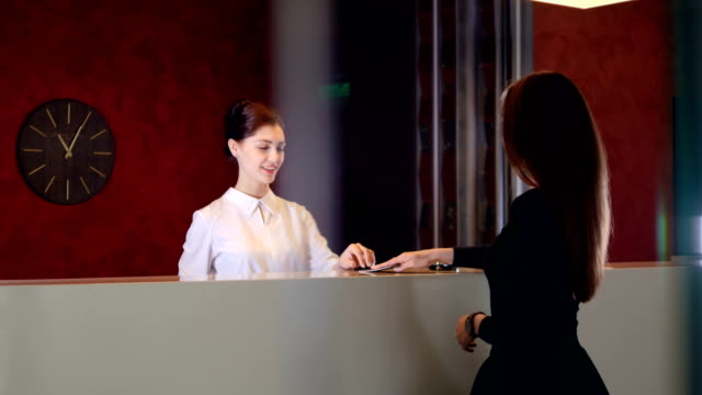 Service-manager-at-hotel-lobby-meets-visitor.-4K.