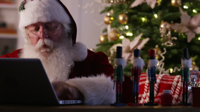 Santa-Claus-in-workshop-using-computer