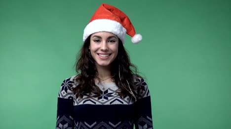 brunette-woman-in-a-red-santa's-cap-smiling