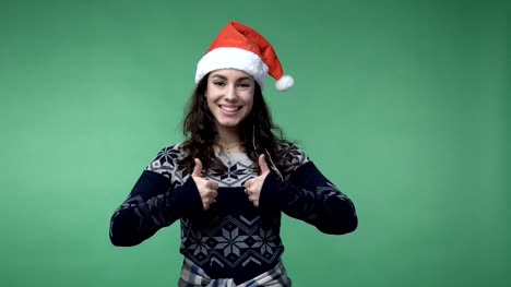 woman-in-santa's-cap-showing-thumbs-up-and-smiling