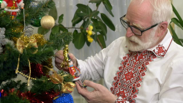 Old-attractive-man-holds-christmas-tree-toy