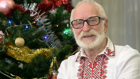Cute-old-man-laughs-near-the-christmas-tree