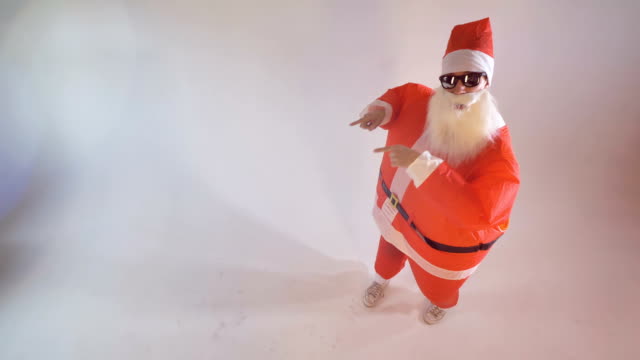 Santa-in-sunglasses-pointing-on-something.