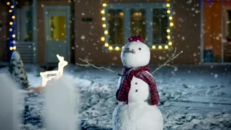 Funny-Snowman-Wearing-Hat-and-Scarf-Standing-in-the-Backyard-of-the-Idyllic-House-Decorated-with-Garlands-on-Christmas-Eve.-Soft-Snow-is-Falling-on-that-Magical-Winter-Evening.