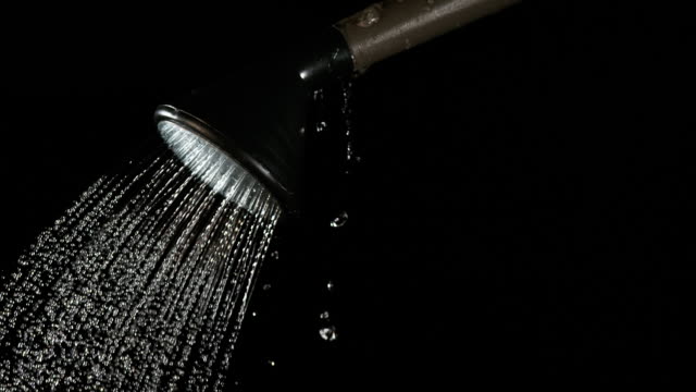 Water-Flowing-From-a-Watering-Can-on-Black-Background,-Slow-Motion-4K