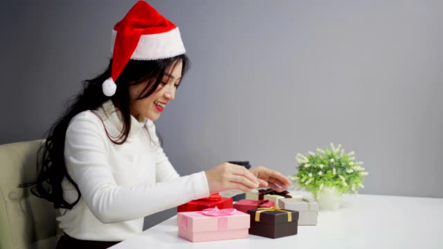 überrascht-Frau-in-Santa-hatte-Eröffnung-Weihnachts-Geschenk-box