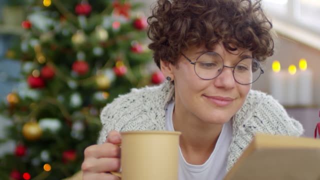 Woman-Reading-Book-at-Christmas