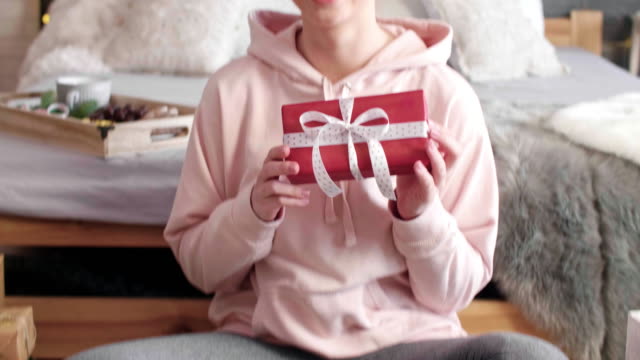 Smiling-girl-showing-the-christmas-presents