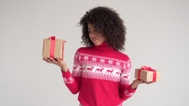 Woman-choosing-between-two-Christmas-presents