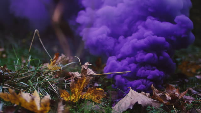 Beautiful-girl-in-a-mask-walks-through-purple-smoke-from-a-color-smoke-grenade,-slow-motion