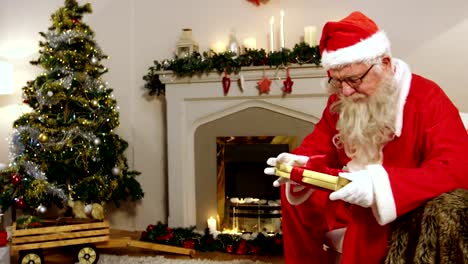 Santa-claus-holding-christmas-gift-