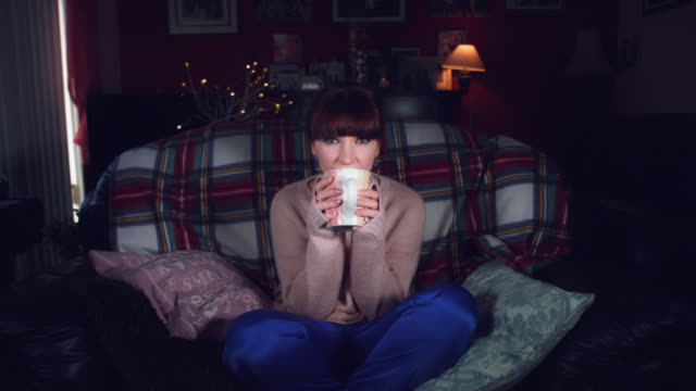 4k-Authentic-Shot-of-a-Woman-Drinking-Tea-on-Couch