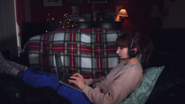 4k-Authentic-Shot-of-a-Woman-Working-with-Headphones-and-Laptop