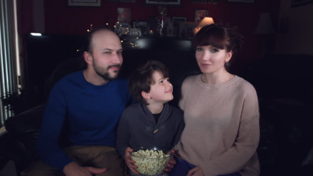 4k-Authentic-Shot-of-a-Funny-Family-Watching-Movie-with-Popcorn-and-Dancing