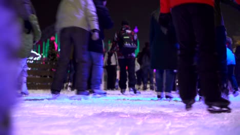 Concept-Closeup-Winter-Sport.-Crowd-at-Night-City-Skating-Rink-Pedestal-and-Blur