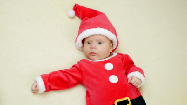 Cute-little-baby-boy-lie-wearing-Santa-Claus-hat.