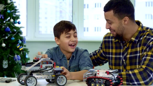Father-and-son-play-with-toy-SUV