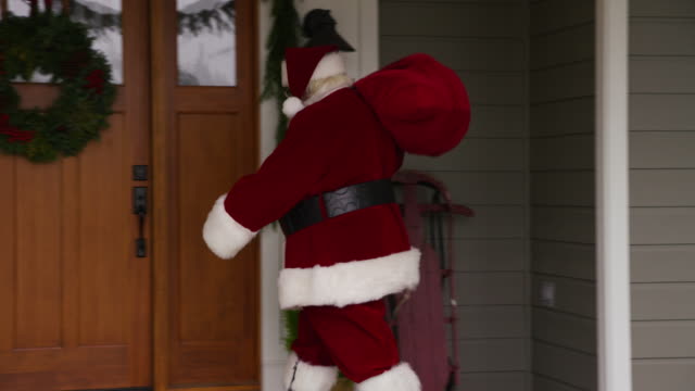 Santa-Claus-going-into-front-door-of-home