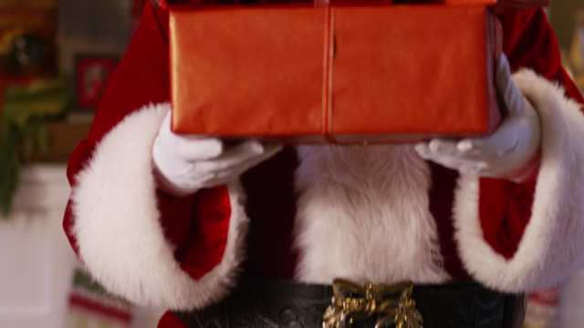 Santa-Claus-peeks-desde-detrás-de-montón-de-regalos