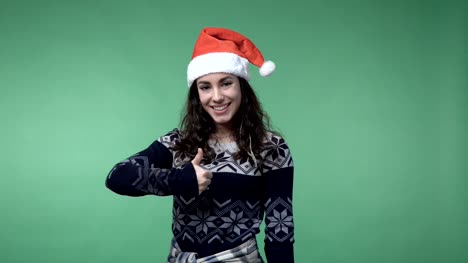 woman-in-santa's-cap-showing-thumb-up-and-smiling