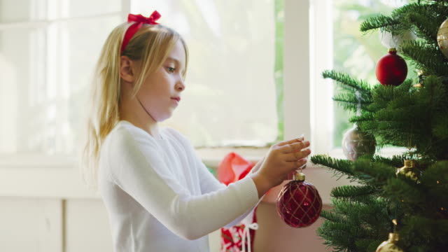 Young-Girl-Decorating-Christmas-Tree