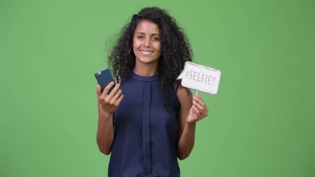 Young-beautiful-Hispanic-businesswoman-using-phone