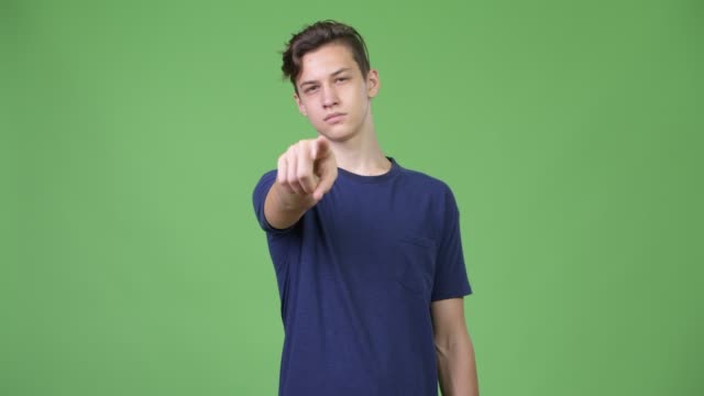 Young-handsome-teenage-boy-pointing-to-camera