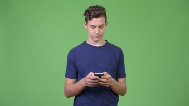 Young-handsome-teenage-boy-using-phone