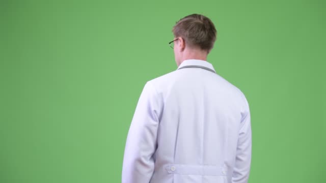 Back-View-Of-Young-Man-Doctor-Turning