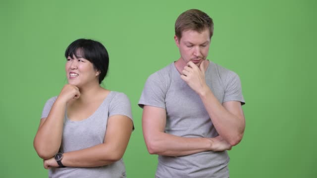 Young-multi-ethnic-couple-thinking-differently-together