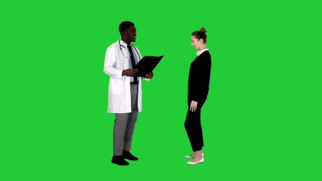 Physician-showing-a-patient-the-X-ray-results-Then-patient-leaves-on-a-Green-Screen,-Chroma-Key